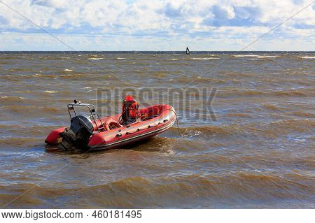 Rescue Motor Boat Is Red On The Surface Of The Water. Storm At Sea. The Concept Of Rescue On The Wat