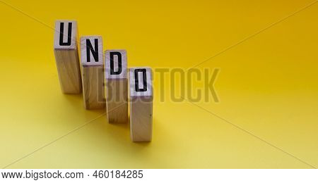 Undo Word On Wooden Cubes With Letters On Yellow Background. The Concept Of A Computer Program Techn