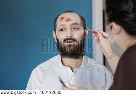 Makeup Artist Using Special Effects To Create Zombie Costume And Scary Dramatic Corpse Look. Man Loo