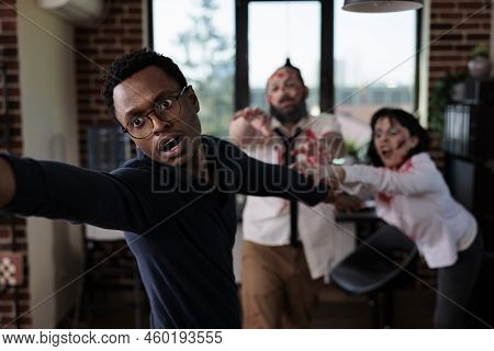 Afraid Man Running From Scary Zombies, Trying To Eat Human Brain In Business Startup Office. Bloodth