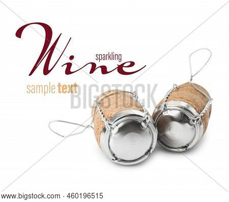 Sparkling Wine Corks With Muselet Caps On White Background. Space For Design