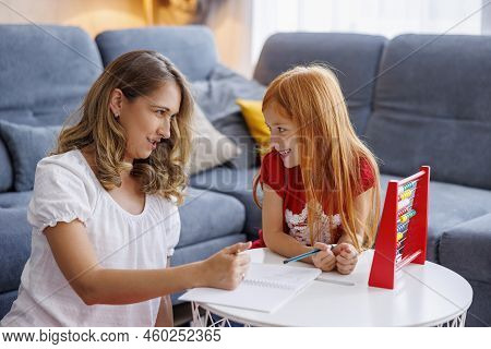 Mother Helping Daughter With School Project And Homework, Studying Math, Practicing Summation And Su