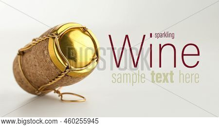 Sparkling Wine Cork With Muselet Cap On White Background. Space For Design