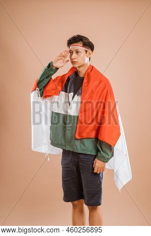 Male Athelete From Indonesia Giving Salute To Indonesian Flag Proudly