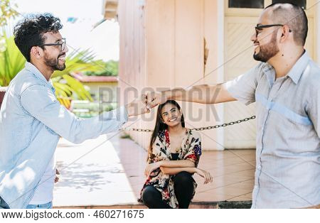 Concept Of Friends Bumping Fists Amicably, Two Overjoyed Male Friends Bumping Fists Amicably On The