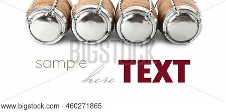 Sparkling Wine Corks With Muselet Caps On White Background, Banner Design. Space For Design