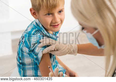 Female Doctor Making Injection To Little Boy