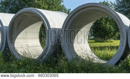 Reinforced Concrete Storm Sewer Pipes Of Large Diameter Stacked At A Construction Site. Sewer Large 
