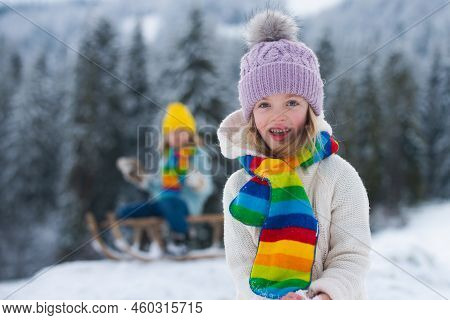Lovely Joyful Girl Lpaying In The Winter Forest. Funny Excited Child Girl Face In Snow On Winter Out