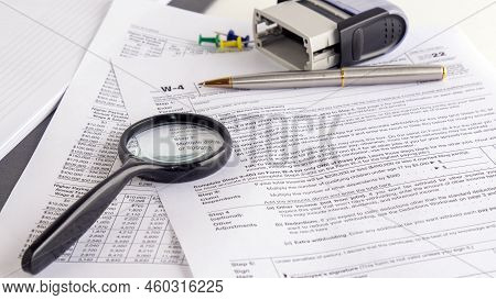 Blank W4 Tax Form, Magnifying Glass And A Pen On Table, Tax Season, Business Concept