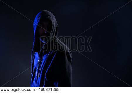 Man In Hood On Dark Background, Space For Text. Cyber Crime
