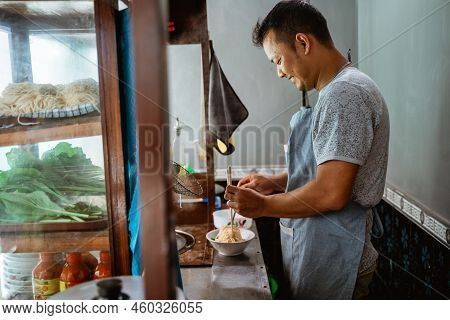 Man Seller Mixing Noodles With In A Bowl