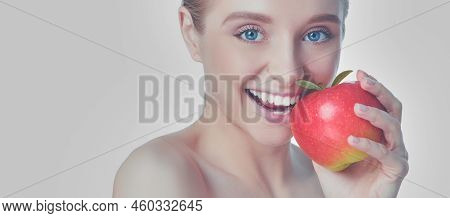 Portrait Of Happy Smiling Young Beautiful Woman Eating Red Apple, Over White Background