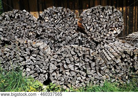 A Large Amount Of Firewood Under A Blue Sky