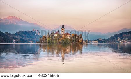 Amazing Sunset Over Popular Tourist Destination  Bled Lake. Dramatic View Of Pilgrimage Church Of Th