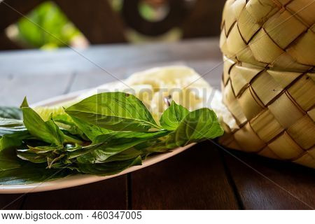 Bamboo Wicker Sticky Rice Basket And Vegetable Side Dish.