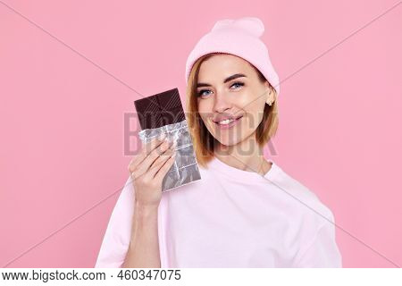 Blonde Woman In T-shirt And Hat Holding Chocolate Bar