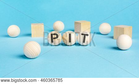 Concept Text 'pit' On Wooden Spheras On A Beautiful Blue Background. Business Concept. Copy Space. P