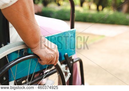 An Elderly Person Sitting On A Wheelchair Making It Possible To Travel To Various Places Easily. The