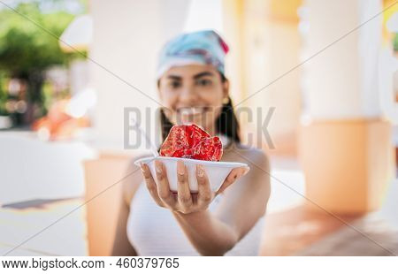 Smiling Girl Holding Shaved Ice On The Street. Close Up Of Young Woman Holding A Shaved Ice In The S