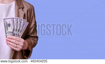 Woman Teacher Holding Money In Bills Of 50 Dollars In Her Hands On A Blue Background, Banner Close-u