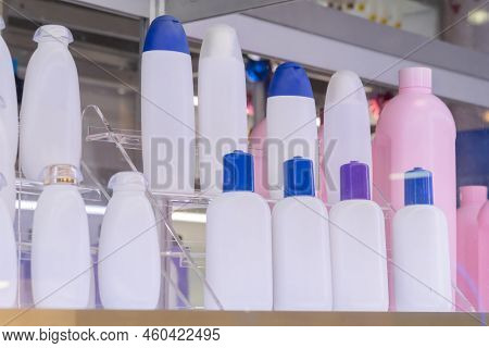 Empty White And Pink Plastic Shampoo Or Shower Gel Bottles In Showcase At Package Cosmetic Exhibitio