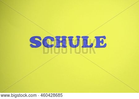 Word Schule Means School. Yellow Background, Blue Letters