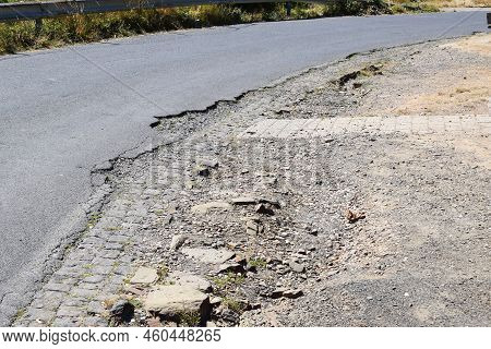 Bad Pothole On The Edge Of An Old Road