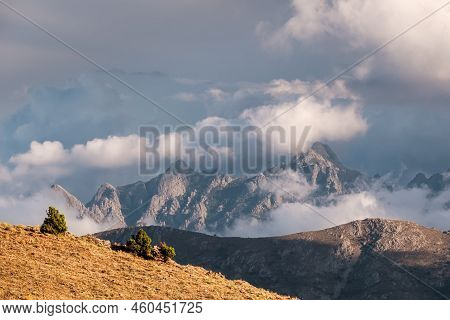 Dark Clouds Over The Craggy Mountain Peaks Of Punta Cavallare, Pinzi A I Giuelli And Turone Lit By E