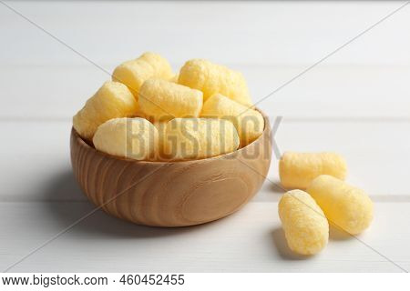 Bowl Of Delicious Crispy Corn Sticks On White Wooden Table