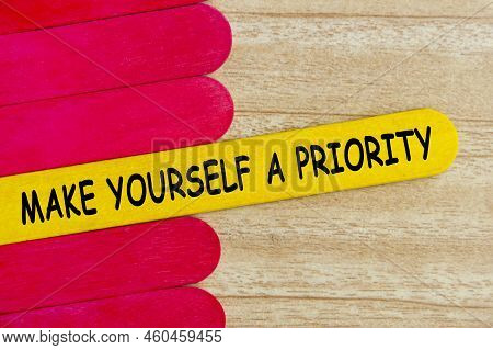 Make Yourself A Priority Text On Yellow Stick Surrounded With Red Sticks. Inspirational And Motivati
