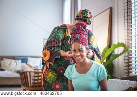 An African American Woman Attractive And Young Is Getting Dressed, Starting With A Headdress, Which 