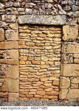 Ancient Doorway Sealed Into A Limestone Wall Found In A Street In St Leon Sur Vezere