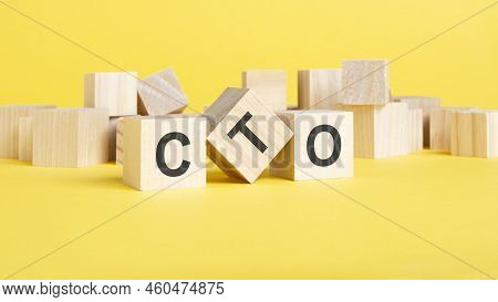 Wooden Blocks With Text Cto On Yellow Background. Cto - Short For Chief Technology Officer