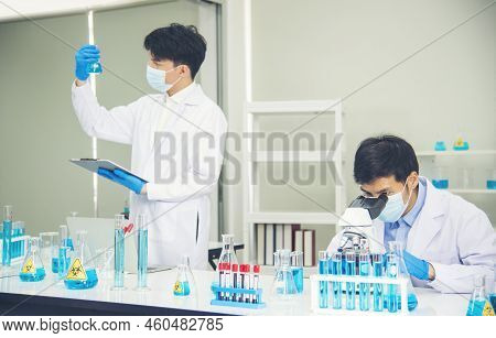 Two Asian Scientist Team Reserch Chemistry Science Tube Experiment Biotech Antibody Sample In Labora