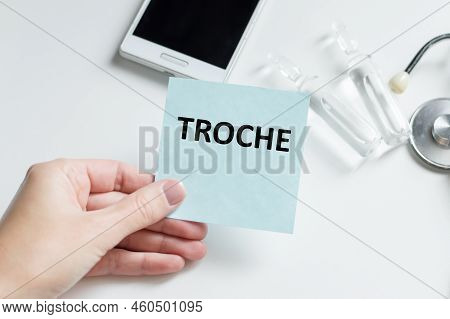 Doctor Holding A Card With Text Troche, Medical Concept