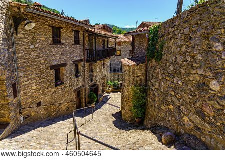 Narrow Alley That Descends To The River With Houses On Both Sides Made Of Stone And Wooden Balconies