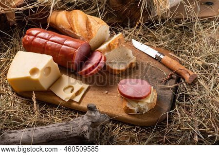 Slicing Sandwiches From Sausage And Hard Cheese. Fresh Baguette And Sausage. View From Above.