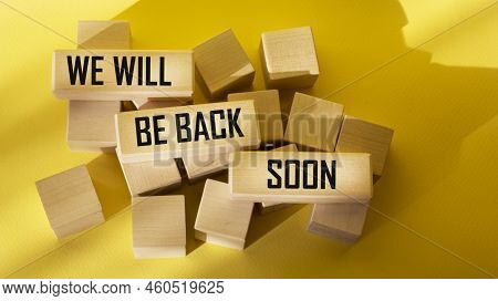 We Will Be Back Soon, Text On Wooden Blocks And Yellow Background