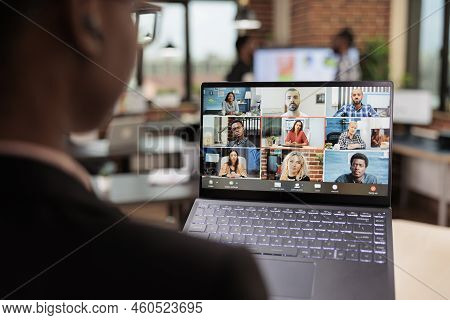 Office Employee Attending Business Meeting On Remote Videocall, Using Laptop And Webcam To Talk To C