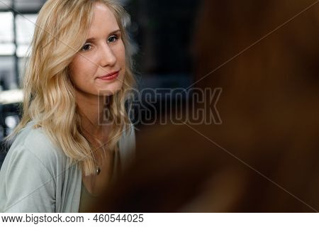 Caucasian Young Woman With Blond Hair Looking And Listening Attentively To Manager Briefing Project 