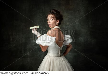 Shock. Young Scared Adorable Girl In Image Of Medieval Royal Person Or Viscountess Tasting Sweets Is