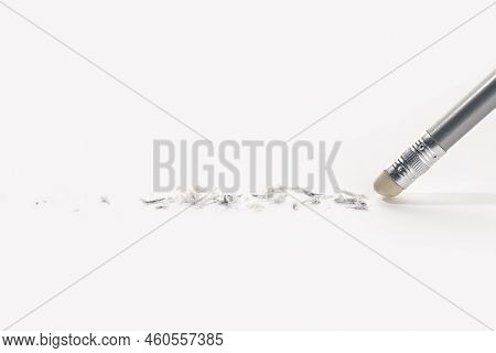 Pencil Eraser Working On White Paper Background. Mistake, Erasing Or Correction Concept. Copy Space