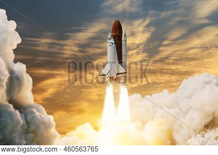 Spaceship Lift Off. Space Shuttle With Smoke And Blast Takes Off Into Space On A Background Of Sunse
