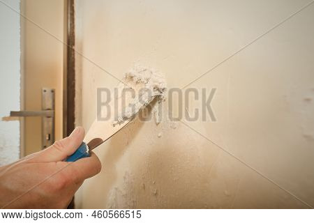 Detail Of Removing Old Wallpapers In Apartment Room