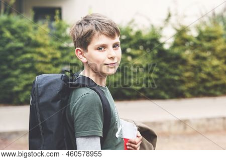 Happy Preteen Kid Boy With Backpack Or Satchel. Schoolkid In On The Way To Elementary Or Middle Scho