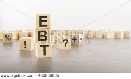 Ebt Text As A Symbol On Cube Wooden Blocks. Many Wooden Blocks With Symbol In The Background. Ebt - 