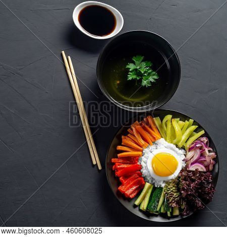 Korean Dish, With A Variety Of Appetizers With Vegetables And Eggs. Diet. Bibimbap. Top View. Round