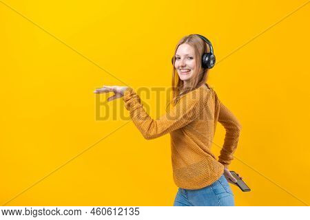 Woman Dancing To Music While Listening To Mp3 Player With Wired Headphones. Energy Move Of Caucasian