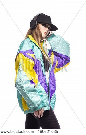 Closeup Portrait Of Young Caucasian Female  Sportwoman In Fitness Outfit And Baseball Cap With Wirel